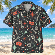 Front view of Atomic Motion Mechanic Hawaiian Shirt with original atomic starbursts and curved motion paths around generic pistons, spark plugs, wrenches, toolboxes and gears