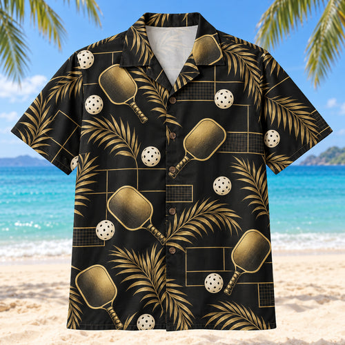 Front view of Black Gold Pickleball Hawaiian Shirt with stylized antique-gold pickleball paddles, perforated ivory balls, slender palm fronds and understated court-line grids