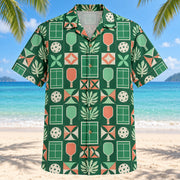Front view of Court Tile Mosaic Pickleball Hawaiian Shirt with structured geometric tiles alternating stylized court diagrams, plain pickleball paddles, perforated balls and minimal leaves