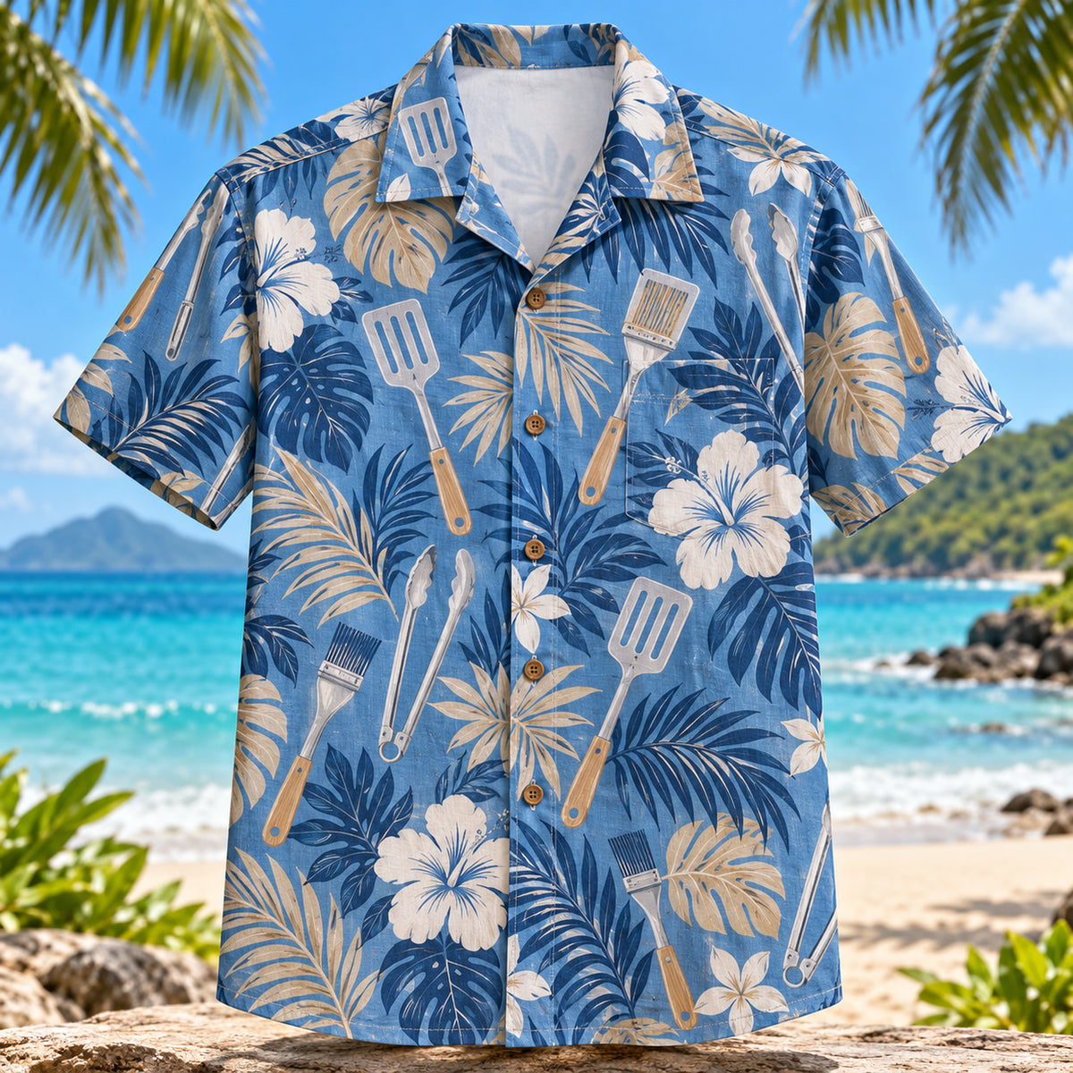 Front view of Grill Tools BBQ Hawaiian Shirt with generic spatulas tongs and brushes among tropical leaves