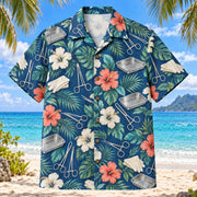 Front view of Instrument Garden Surgical Technologist Hawaiian Shirt with original generic clamps, rounded scissors, empty instrument trays, unmarked gloves and tropical hibiscus foliage