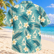 Back view of Microscope Leaves Aqua Sand Medical Laboratory Technologist Hawaiian Shirt on a Hawaiian beach with fine white or light yellow sand and no dark rocks