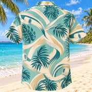 Back view of Movement Coast Aqua Sand Athletic Trainer Hawaiian Shirt on a Hawaiian beach with fine white or light yellow sand and no dark rocks