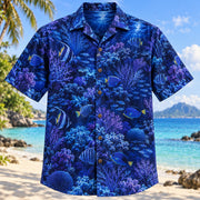 Front view of Reef Night Glow Reef Aquarium Hawaiian Shirt with reef fish and corals under blue night light