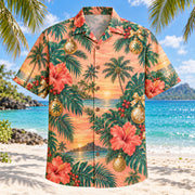 Front view of Sunset Ornament Christmas Hawaiian Shirt with holiday ornaments among sunset palms and hibiscus