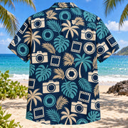 Back view of Tropical Photowalk Hawaiian Shirt with text-free generic camera silhouettes, aperture icons, empty film frames and palm leaves