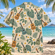 Back view of Ukulele Plumeria Hawaiian Shirt with generic four-string ukuleles, plumeria, monstera and string curves